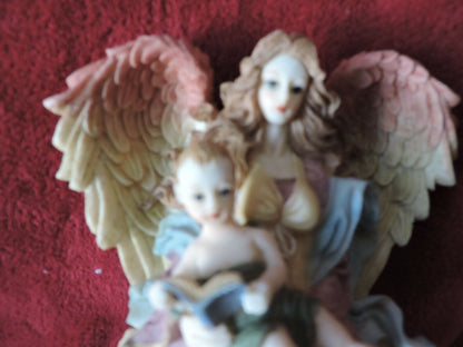 ANGEL HOLDING BABY PORCLAIN FIGURINE