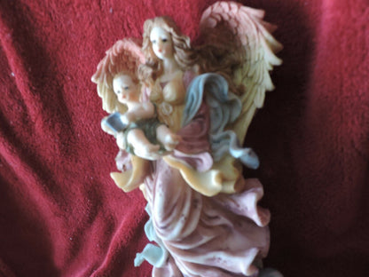 ANGEL HOLDING BABY PORCLAIN FIGURINE