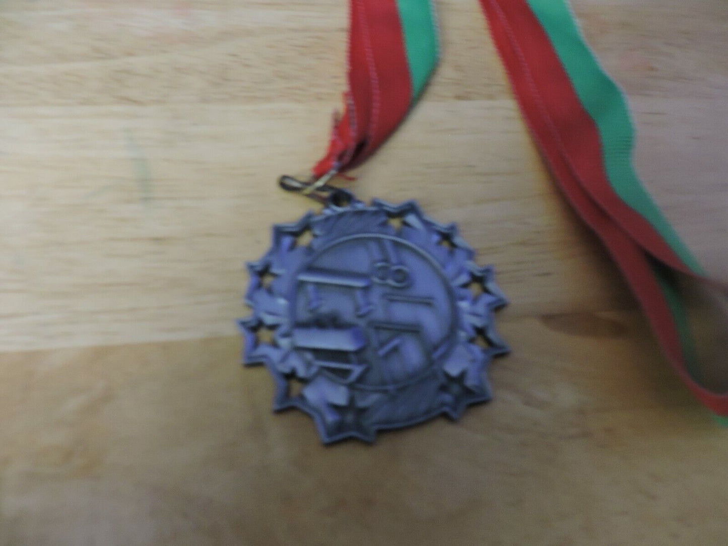 GYMNASTIC SILVER  COLORED 2.5 INCH ROUND MEDAL WITH RED AND GREEN RIBBON