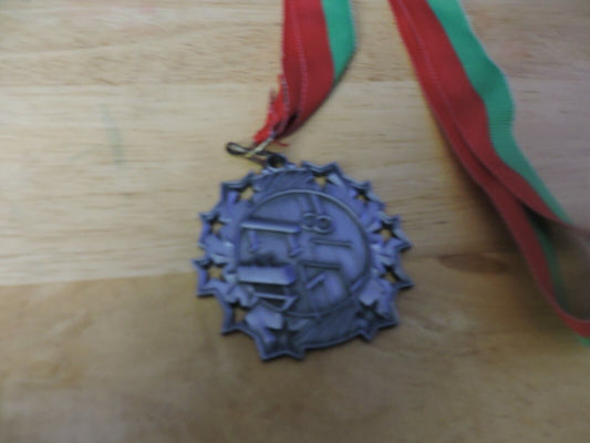 GYMNASTIC SILVER  COLORED 2.5 INCH ROUND MEDAL WITH RED AND GREEN RIBBON