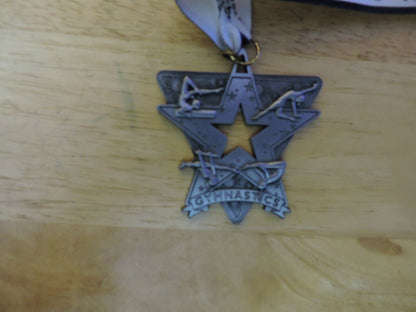 GYMNASTIC SILVER COLORED 2.5 X 2.5 INCH MEDAL WITH WHITE GYMNASTICS RIBBON