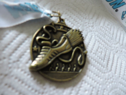 RUNNING MEDAL--2.25 X 2 INCHES WHITE RIBBON WITH BLUE LETTERING