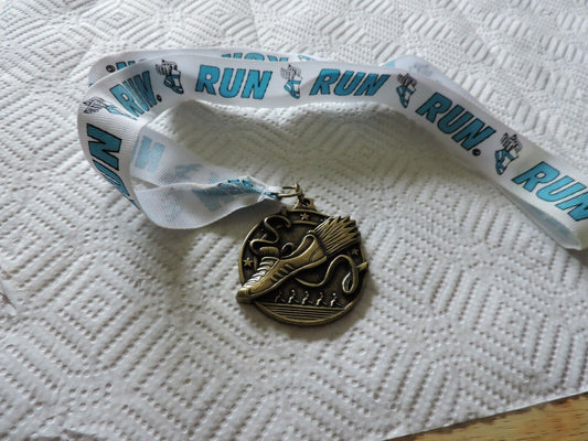 RUNNING MEDAL--2.25 X 2 INCHES WHITE RIBBON WITH BLUE LETTERING