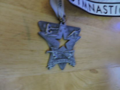 GYMNASTIC SILVER COLORED 2.5 X 2.5 INCH MEDAL WITH WHITE GYMNASTICS RIBBON