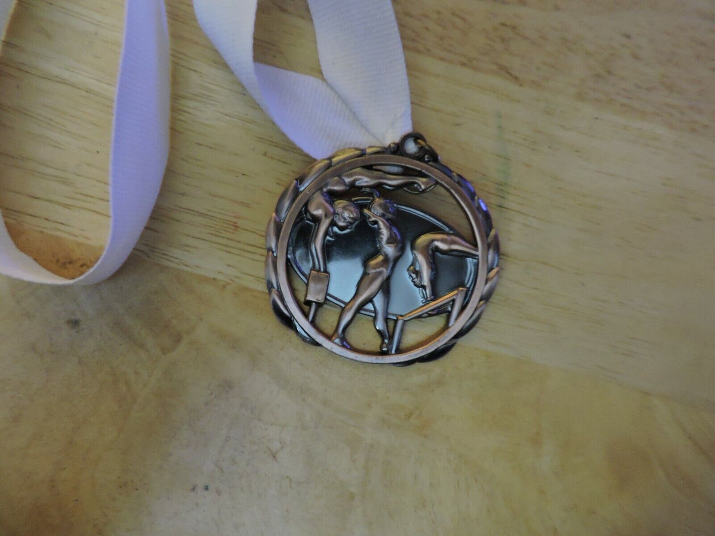 GYMNASTIC BRONZE COLORED 2.5 INCH MEDAL WITH WHITE RIBBON