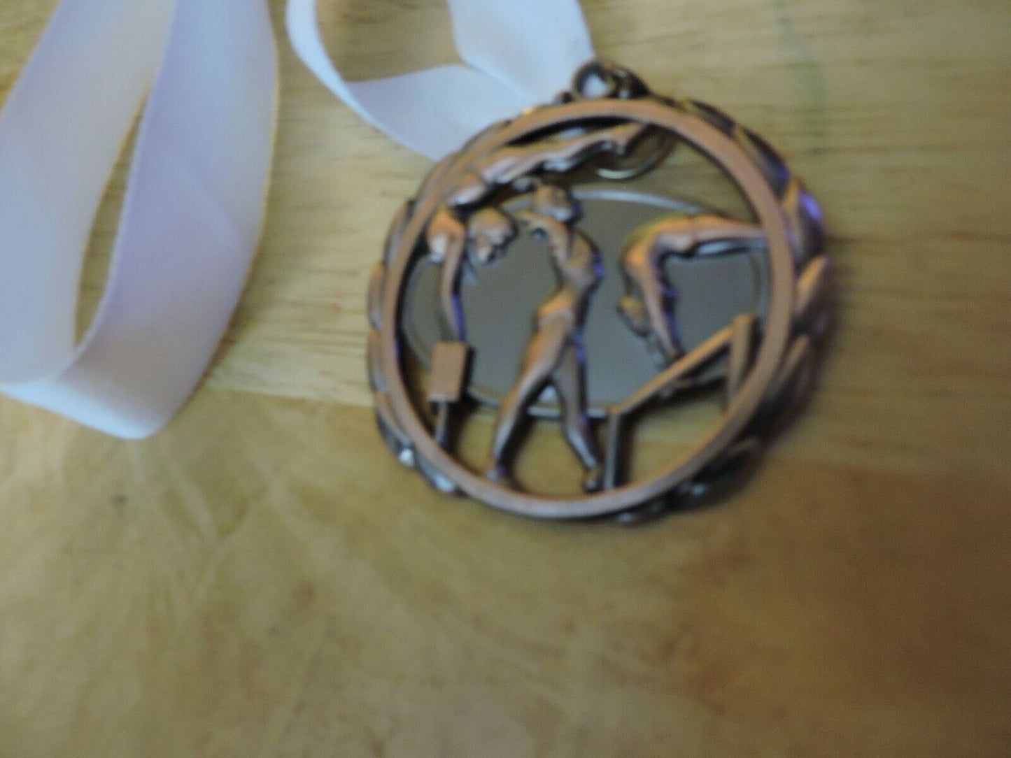 GYMNASTIC BRONZE COLORED 2.5 INCH MEDAL WITH WHITE RIBBON