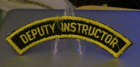 4 1/2" Gold Letters/Black Background Rocker Patch: "Deputy Instructor"
