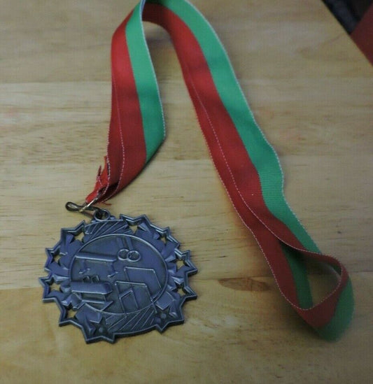 GYMNASTIC SILVER  COLORED 2.5 INCH ROUND MEDAL WITH RED AND GREEN RIBBON