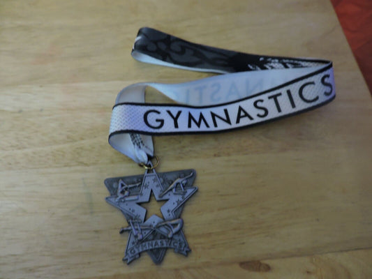 GYMNASTIC SILVER COLORED 2.5 X 2.5 INCH MEDAL WITH WHITE GYMNASTICS RIBBON