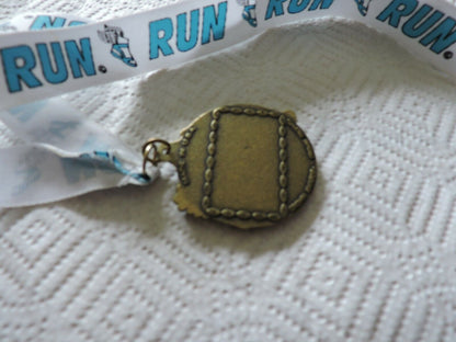RUNNING MEDAL--2.25 X 2 INCHES WHITE RIBBON WITH BLUE LETTERING