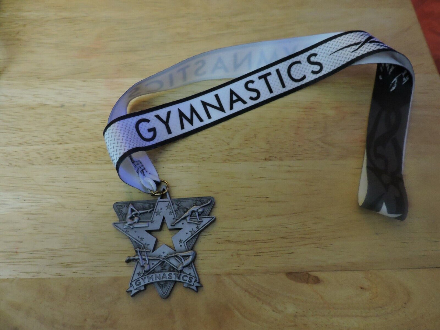 GYMNASTIC SILVER COLORED 2.5 X 2.5 INCH MEDAL WITH WHITE GYMNASTICS RIBBON