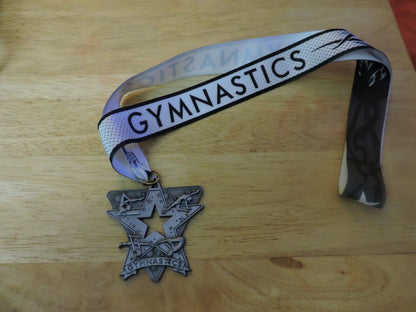 GYMNASTIC SILVER COLORED 2.5 X 2.5 INCH MEDAL WITH WHITE GYMNASTICS RIBBON