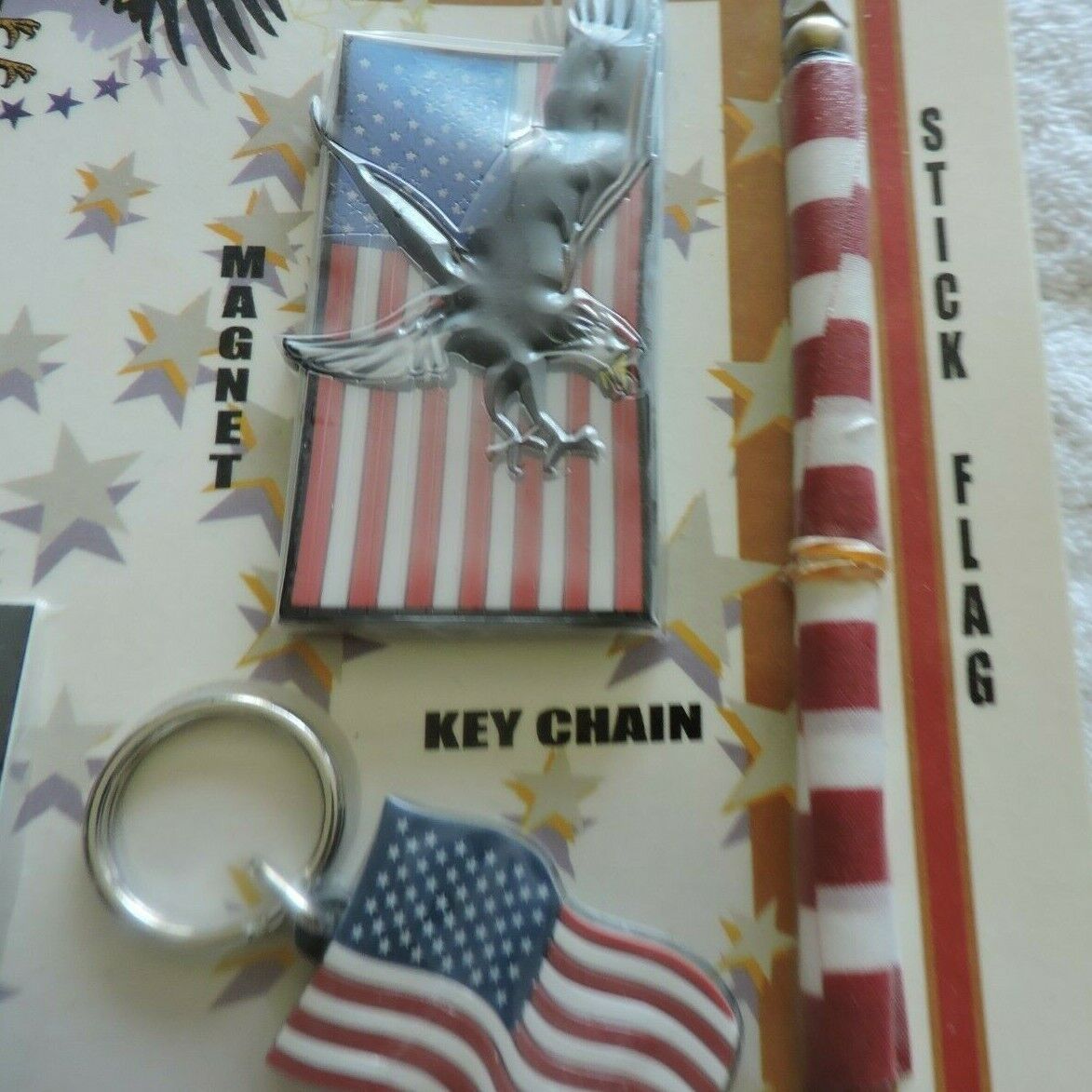 PATRIOT PACKAGE: 2 STICK FLAGS, BELT BUCKLE, MAGNET, 3 FLAG DECALS, 3 LAPEL PINS