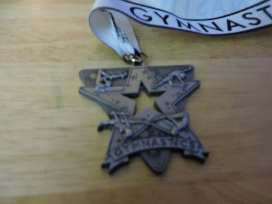 GYMNASTIC SILVER COLORED 2.5 X 2.5 INCH MEDAL WITH WHITE GYMNASTICS RIBBON
