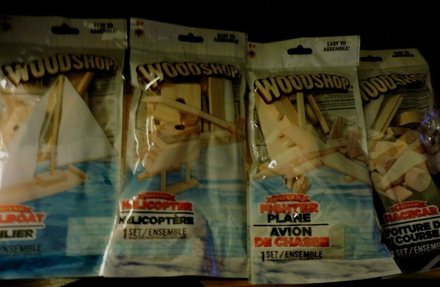 WOODSHOP  SAILBOAT, HELICOPTER, PLANE, RACECAR MODELS SET OF 4: NEW IN PACKAGES