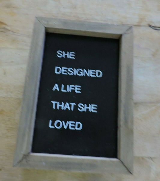 COLLINS BOX SIGN: "SHE DESIGNED A LIFE THAT SHE LOVED"  7X5 INCHES