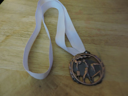 GYMNASTIC BRONZE COLORED 2.5 INCH MEDAL WITH WHITE RIBBON