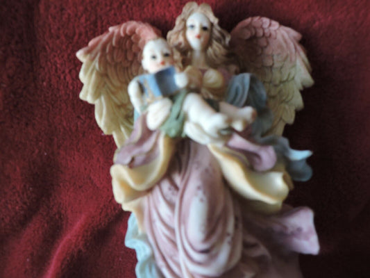 ANGEL HOLDING BABY PORCLAIN FIGURINE